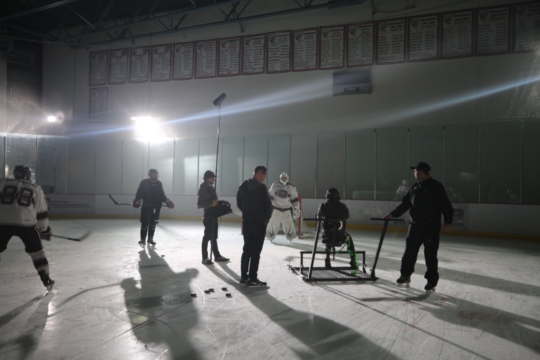 VALIDATE crew filming a hockey scene on an ice rink.