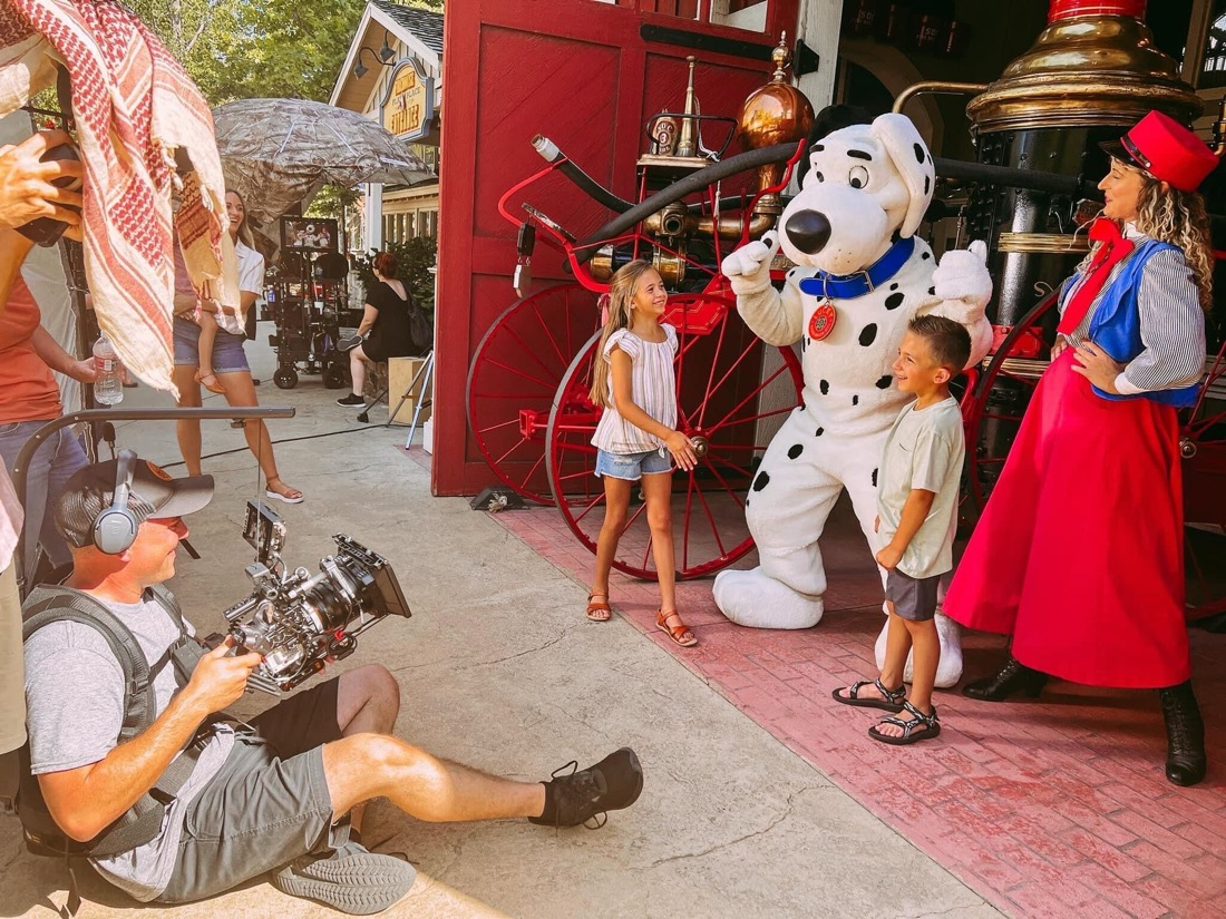 VALIDATE crew filming kids with a theme park character.