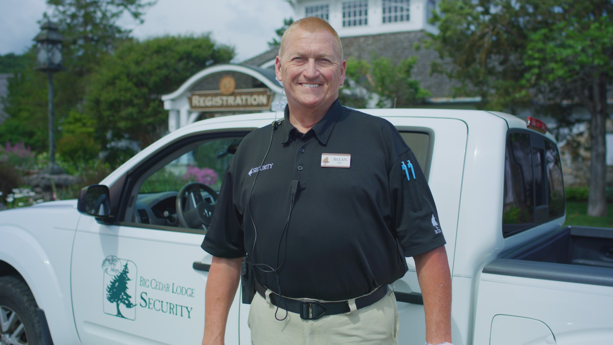 Big Cedar Lodge security team member Allan smiling in front of a resort truck