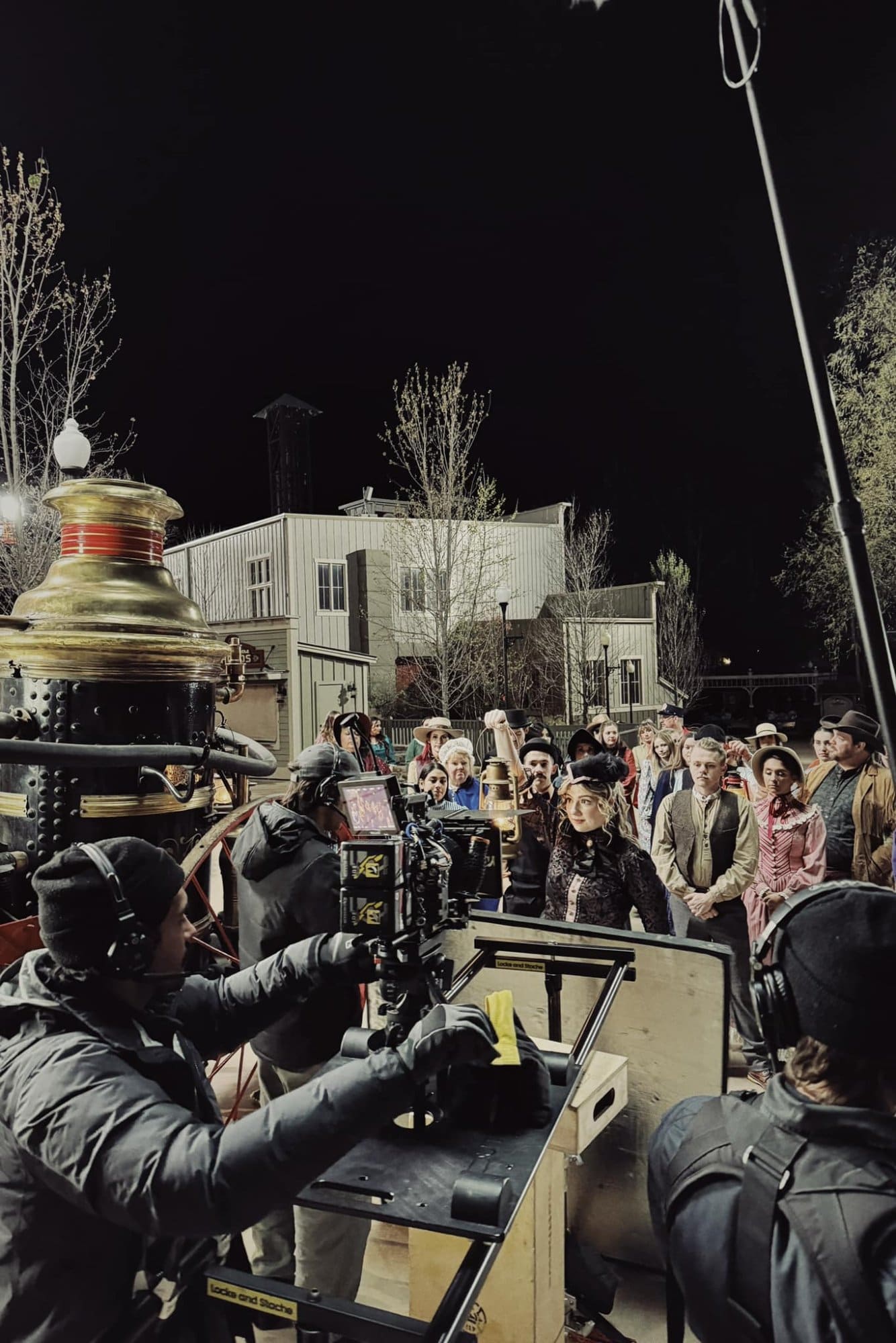 Night shoot with crowd gathered outside the ride entrance