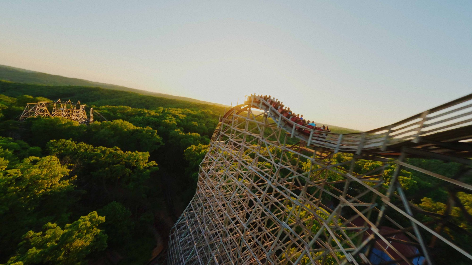 Coaster racing through the Ozark treeline at Silver Dollar City