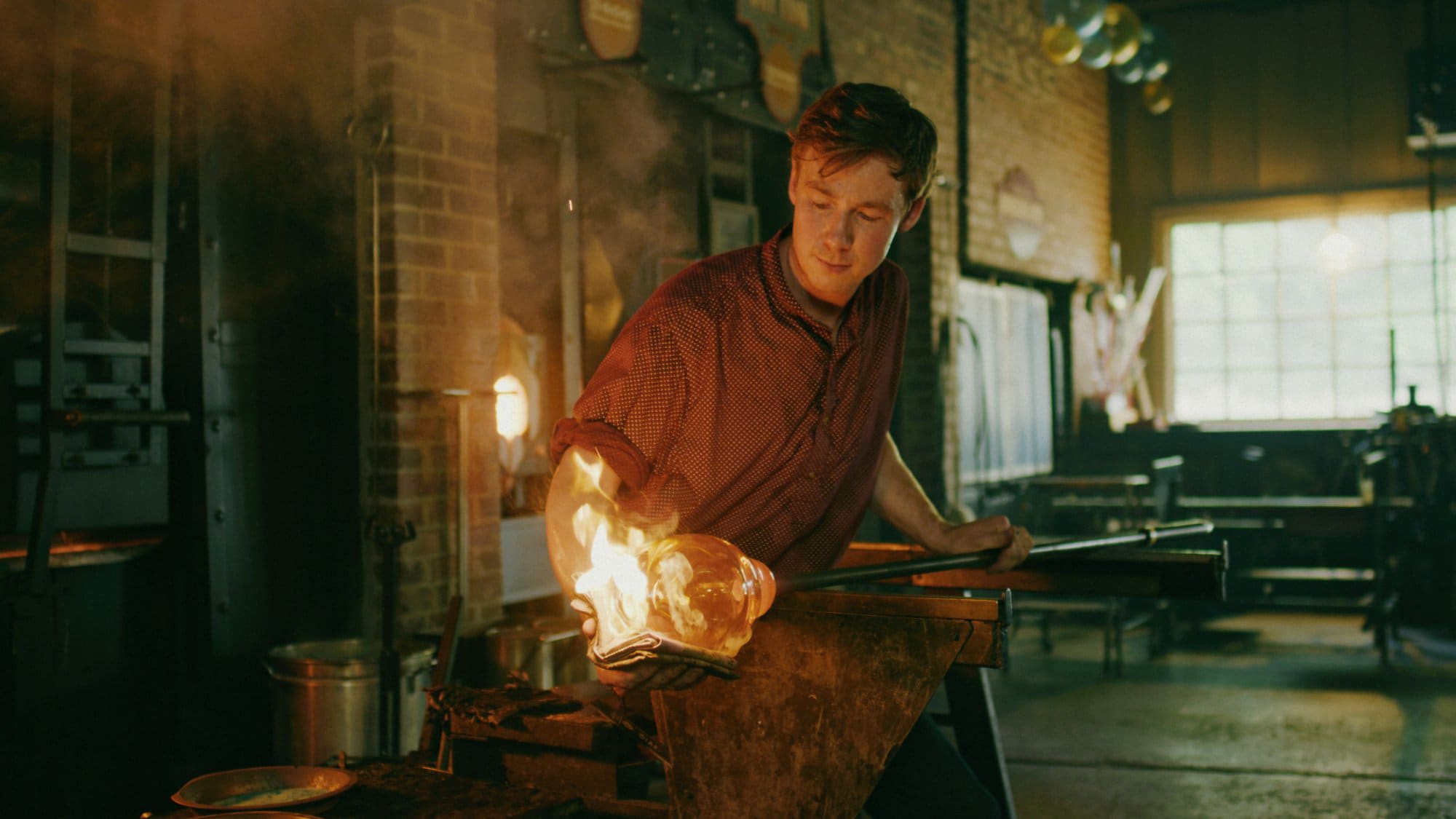 Glassblower shaping molten glass at Silver Dollar City