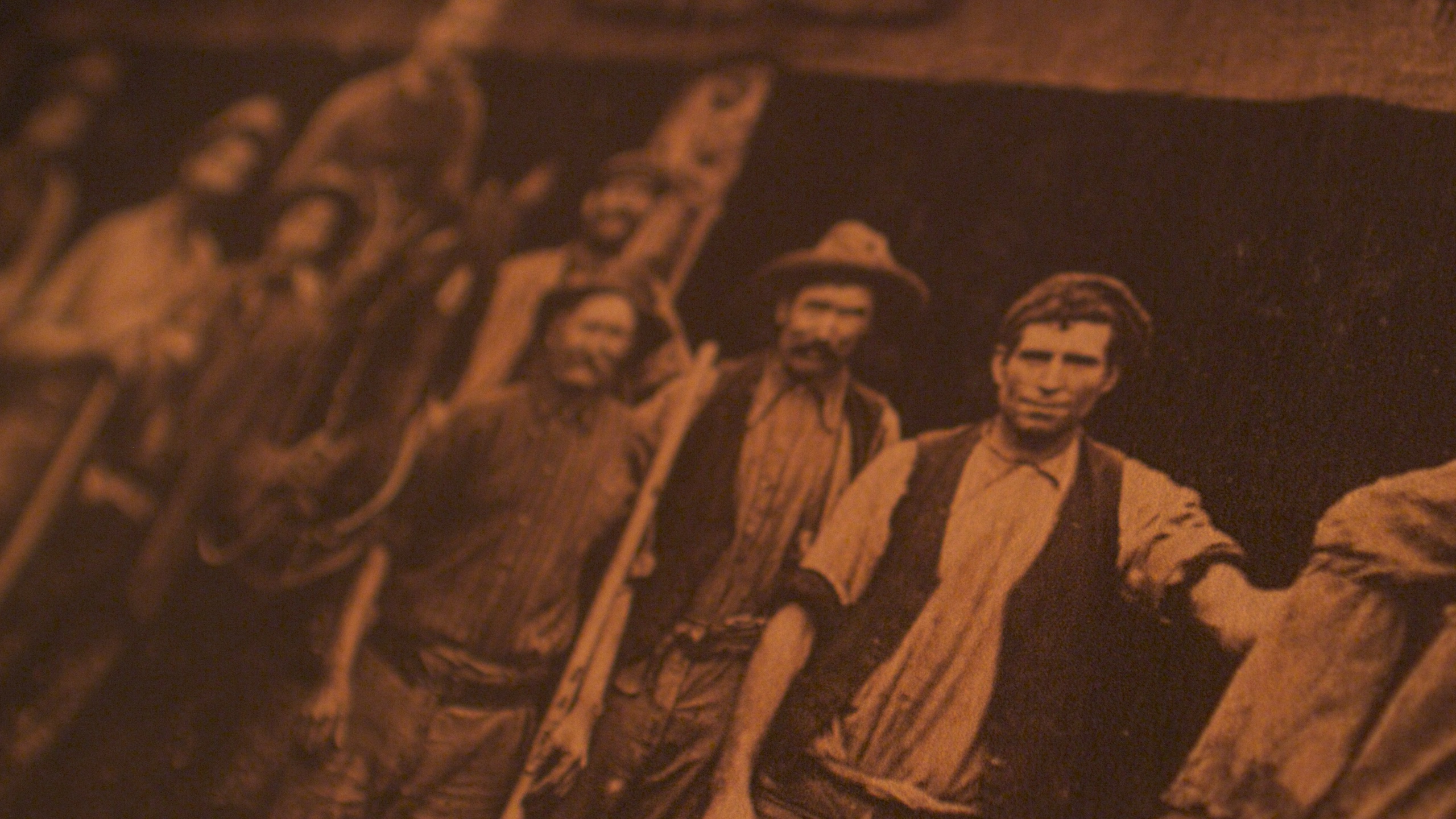 Historic photograph of miners gathered underground