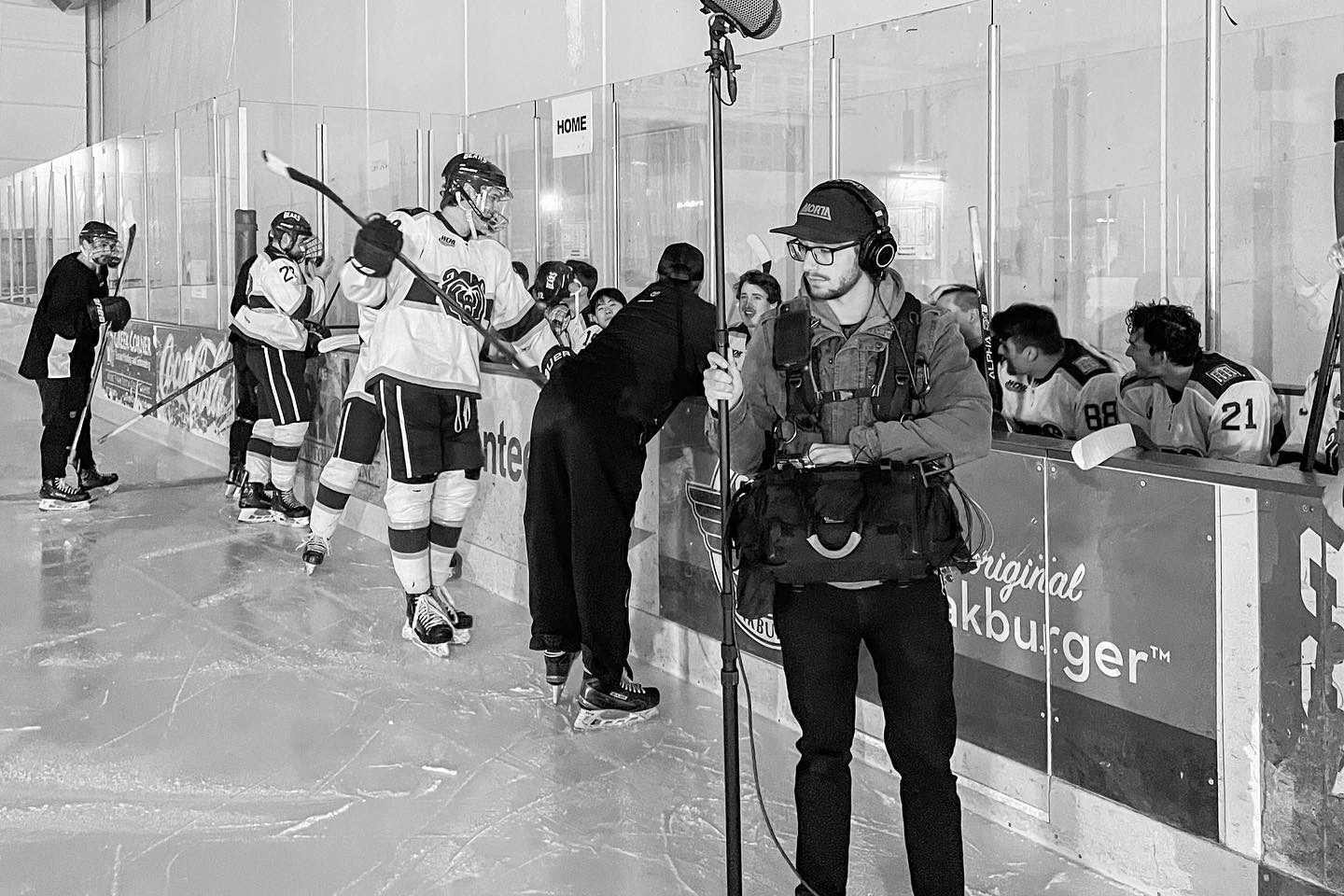 Boom operator recording audio rinkside during the Ice Bears production