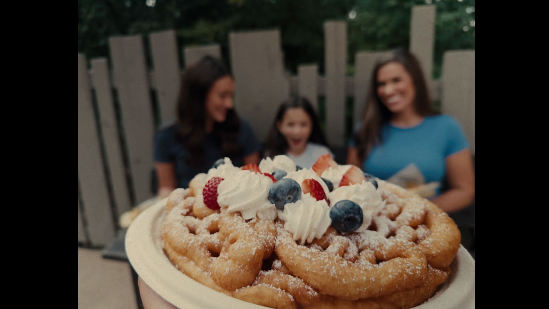 Funnel cakes in the foreground with guests behind them at Silver Dollar City