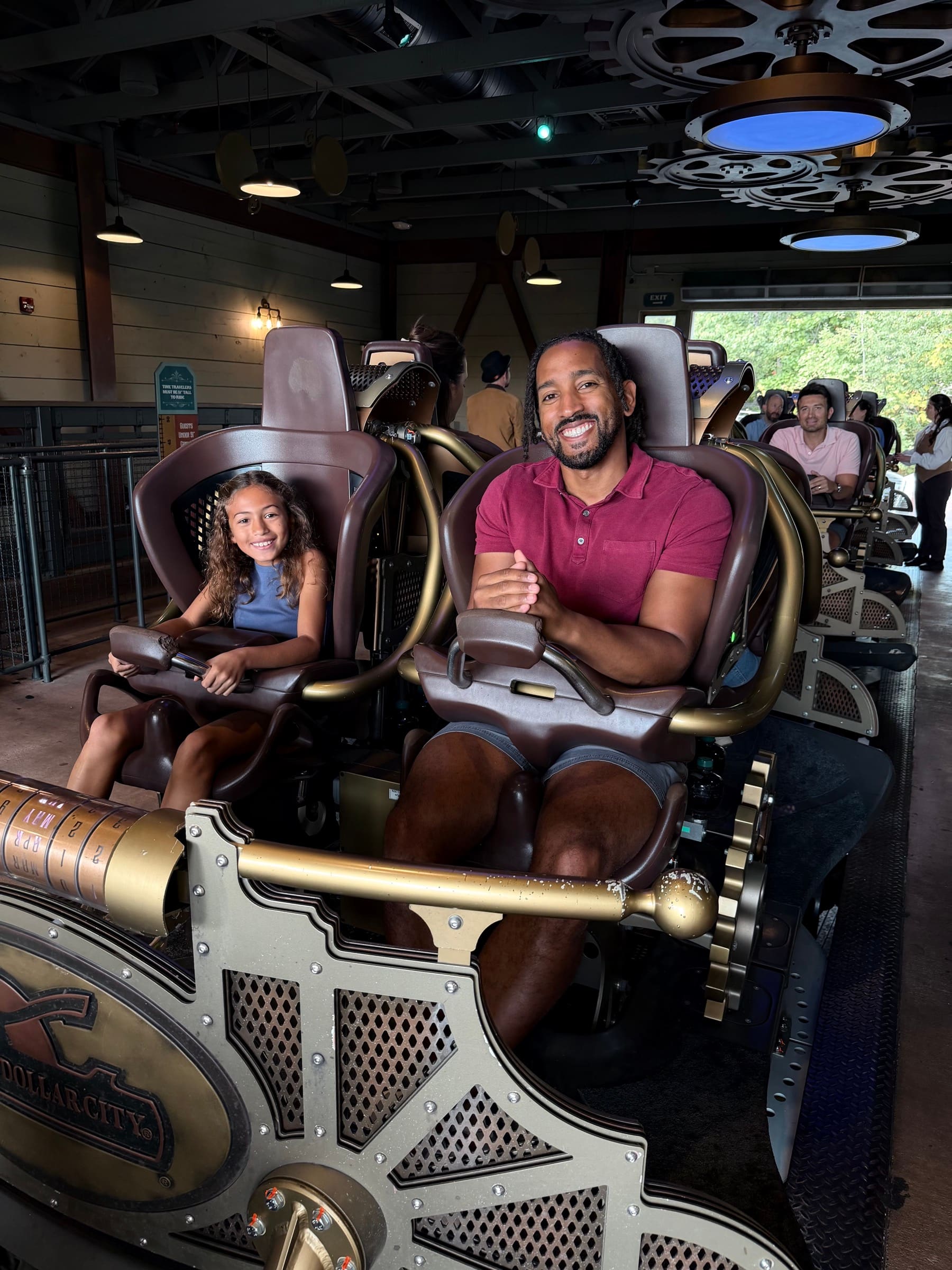 Father and daughter seated on a Silver Dollar City ride during the Season Passports campaign